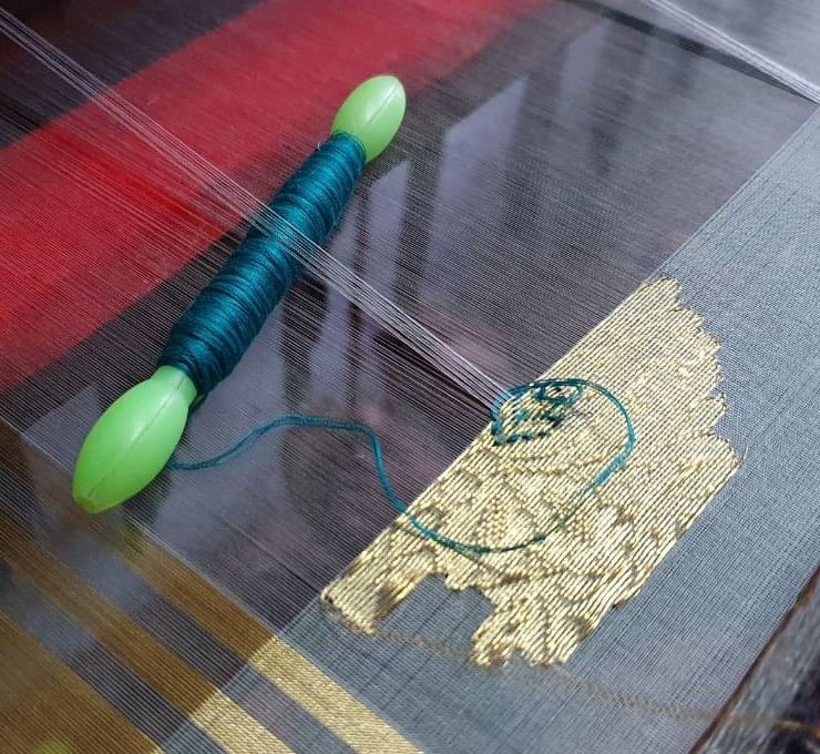A gold zari motif taking shape on a Chanderi loom