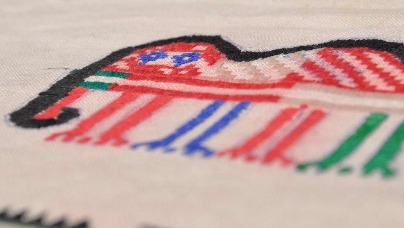 A hand-worked motif in coloured thread on handloom cloth
